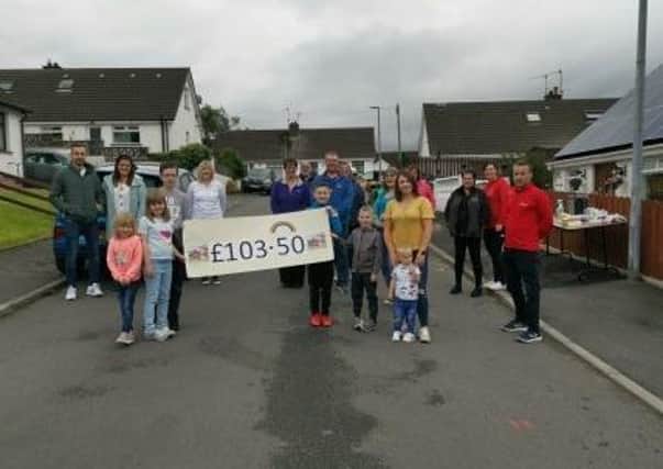 Residents of Lynn Avenue and Lynne Crescent had over cheque for £103.50p to Peter Branker, volunteer ambassador for Air Ambulance NI