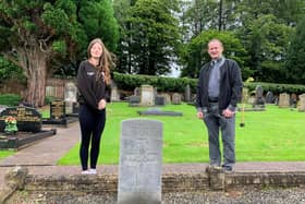 Lance Corporal Cadet Alicia McGorrey and Rev Adrian Halligan of Craig’s Parish Church Cullybackey stand beside the cleaned headstone of Gunner John McIlroy Foster