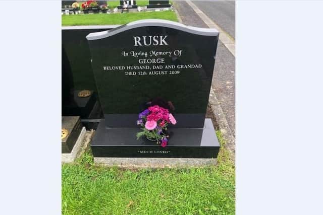The grave of George Rusk with flowers.