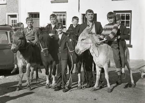 At the races: Boys having fun at the Oul Lammas Fair in years gone by. Photo: Chronicle and Constitution Archive, Coleraine Museum.