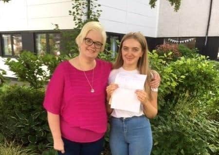 Amy Campbell celebrating her seven A stars and four As with her mum.