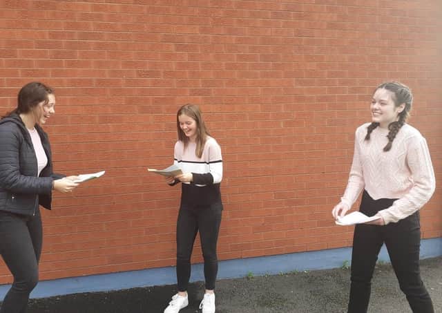 A happy trio of St Louis GCSE students on Thursday