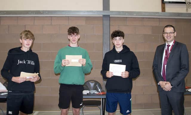 Banbridge Academy pupils Seb Best, James Finlay, Charlie Rowe pick up their results