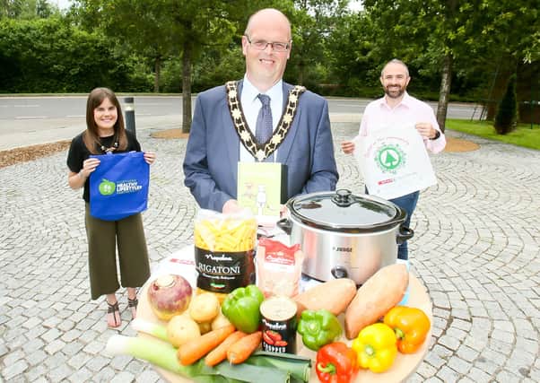 Mayor of Antrim and Newtownabbey, Cllr Jim Montgomery with Michael Surginor, Henderson Retail and Kelly Forsythe, Environmental Health Officer.