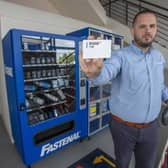 Jason Halberg, Fastenal's District Manager, demonstrates the contactless vending technology