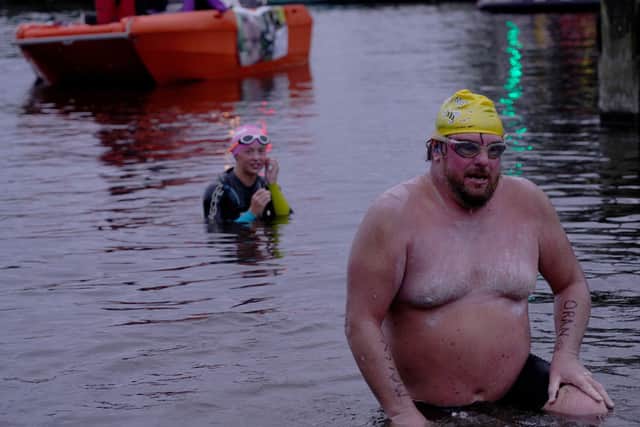 Francie McAlinden has now completed a pioneering swim in Lough Neagh to raise funds for the Make a Wish Foundation in memory of his grandson Oran Creaney.  With support swimmer 14 year old Aimee Dawson from Lurgan ASC in background.