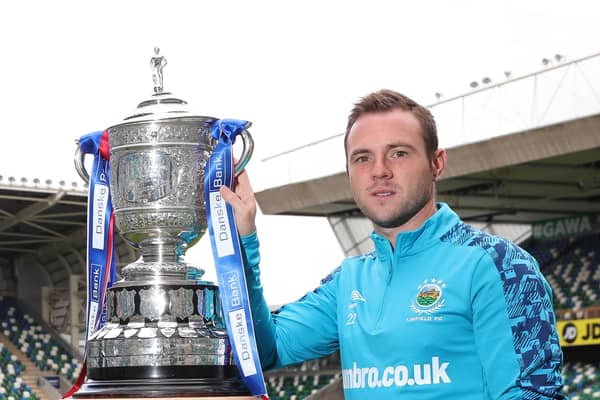 Linfield captain Jamie Mulgrew with last season’s Gibson Cup. Pic by Pacemaker.