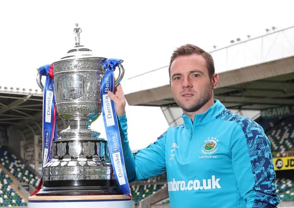 Linfield captain Jamie Mulgrew with last season’s Gibson Cup. Pic by Pacemaker.