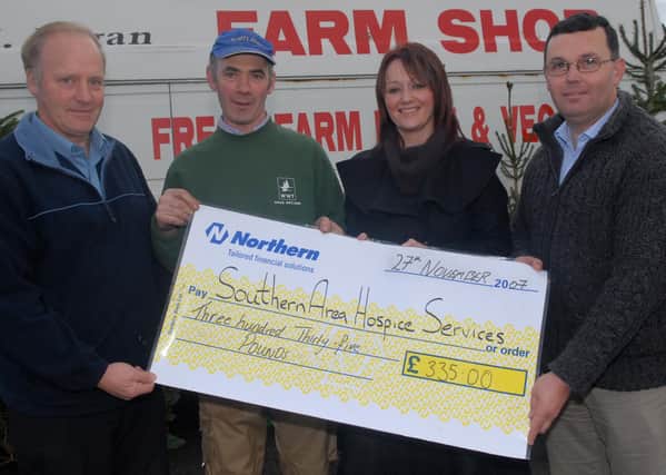 Pictured in November 2007 is Southern Area Hospice Services representative Kristen King receives a cheque for £335 proceeds from the local community ploughing and vintage rally held at Loughbrickland. Included are Robert Irvine, Mervyn Fagen and William McCracken.  Picture: Michael Cousins