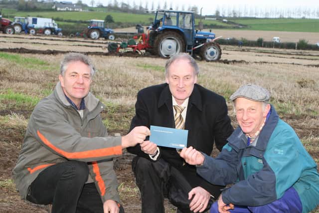 John Taggart Northern Bank Agri Manager presents Andrerw Hyde and Sam Pinkerton with a sponsorship cheque for Killead Ploughing Match.Pic Kevin McAuley