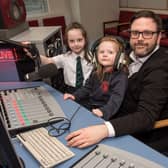 NWRC Journalism student Ciaran Lockhart gives his daughters Niamh and Aoibheann a tour of the media facilities at the college.