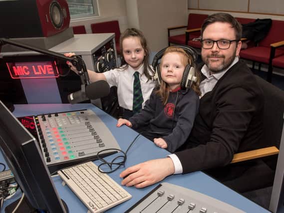 NWRC Journalism student Ciaran Lockhart gives his daughters Niamh and Aoibheann a tour of the media facilities at the college.