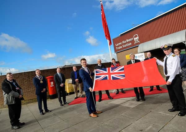 The Mayor of Mid and East Antrim, Councillor Peter Johnston; Harbour Master Stuart Wilson; the Captain of European Causeway or European Highlander; David McCorkell, Lord Lieutenant of Co Antrim and guests at the flag raising ceremony for Merchant Navy Day.