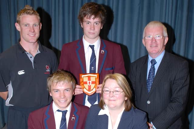 The manager of the Northern Bank in Larne, Joyce Lardie, conratulates Larne Grammar School first XV captain Ryan Garrett on the team's Ulster Schools' Bowl win. The bank also awarded the team members with a £30 gift each. With them are head of P.E. Jonny Lowe, Head Boy David Knox and principal John Wilson. LT30-348-PR