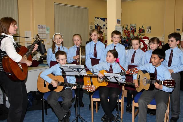 Pupils from St Louis Primary School who entertained visitors to the Celebration Evening held by the NEELB Education & Youth Library Sericies in Ballymena Library Headquarters. Included is teacher Mrs McDonald. BT49-102JC