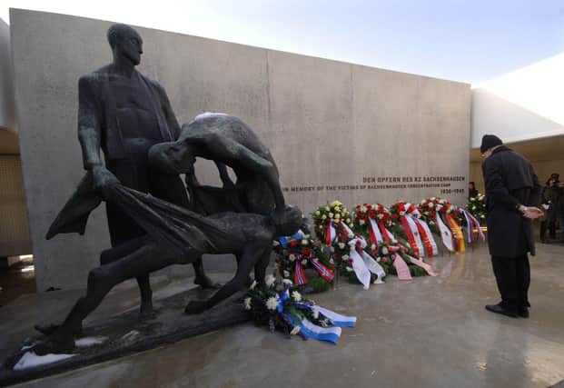 A man pauses after laying down a wreath during a remembrance event in the former Nazi concentration camp of Sachsenhausen in Oranienburg north of Berlin Friday, January 27, 2006. European leaders remembered the Holocaust on Friday, the 61st anniverary of the liberation of the Auschwitz death camp. Soviet troops liberated Auschwitz and the neighboring Birkenau camp on January 27, 1945, as the Second World neared its end