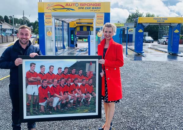 Members of the public have the chance to win a painting of the Down 1960 All Ireland Winning team and support Southern Area Hospice. Pictured - Carol Murphy presents the painting to James McCaffrey, SAHS on behalf of Soapy Joe's Car Wash.