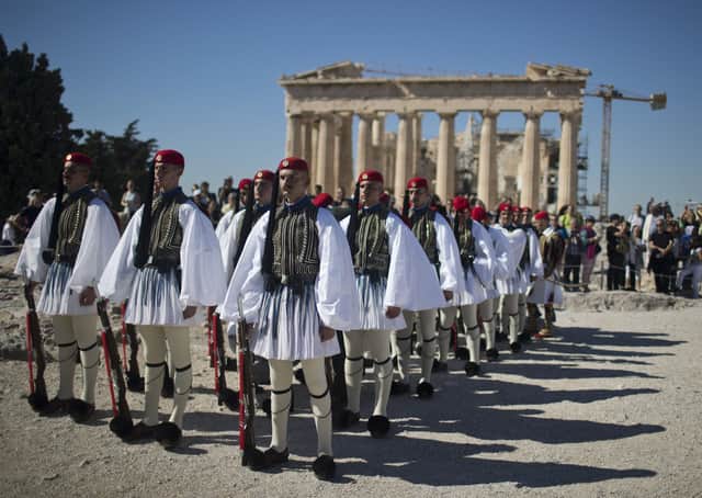 Members of the Presidential Guard stand on the Acropolis of Athens, with the 5th century BC Parthenon temple in the background on Thursday, October 12, 2017, during a ceremony on the 73rd anniversary of the liberation of Athens from Nazi German occupation during the Second World War. Picture: AP Photo/Petros Giannakouris