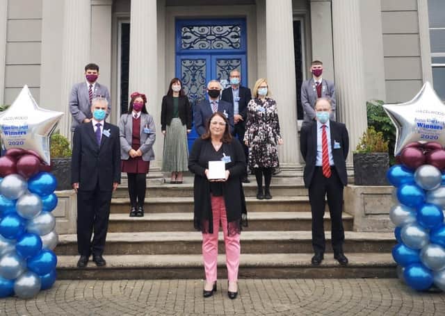 Principal of Hazelwood, Máire Thompson, pictured with staff and students after the award was presented by Education Minister, Peter Weir MLA.