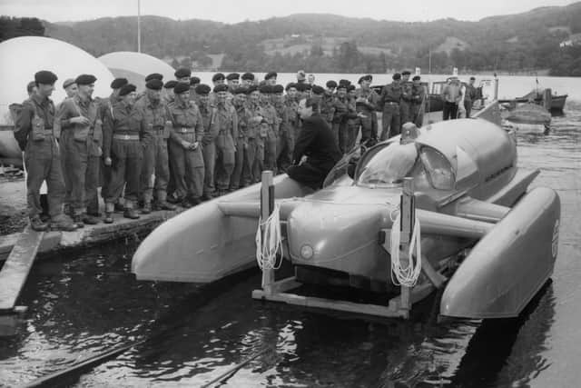 Speedboat record-breaker Donald Campbell (1921-1967), whose boat The Bluebird had reached nearly 240 mph, in October 1958, proudly shows it off to a group of soldiers from the Royal Artillery. Picture: Hulton Archive/Getty Images