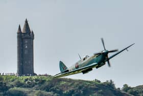 NHS Spitfire flyover of local hospitals.The NHS Spitfire flies past crowds of people on Scrabo Tower in Newtownards after its flyover above the Ulster Hospital and the Newtownards Community Hospital. Photo by Simon Graham