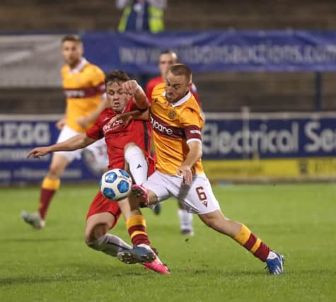 Ben Doherty battles with 
Motherwell's Allan Campbell in Europa League defeat last night for Coleraine. Pic by Pacemaker.