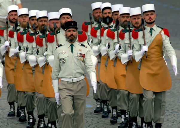 A regiment of French Foreign Legion parade down the Champs Elysees in Paris Tuesday July 14 1998 for the traditional Bastille Day military parade. (AP PHOTO/Michel Euler)