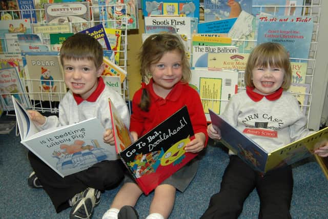 Kernen, Charlie and Amy get down to some reading in the P1 class at Cairncastle Primary School. LT40-318-PR