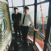 Jim Canning (left) and Gerald McCurdy inspect the huge light in one of Rathlin Island's three lighthouses. The East Light, built in 1856, is the oldest. It became automated in 1995. The Rue Light, at the southern tip opposite fair head, is only 35 feet above sea level. At the western tip of the island is the West Light, built between 1912 and 1916 at the enormous cost in those days of £400,000. All three of the lighthouses stand as monument to its wild coast while over 40 recorded shipwrecks lie in the depths of underwater cliffs and caves. This photograph dates from 1994. (NEWS LETTER ARCHIVES)