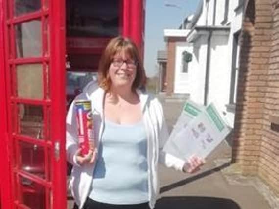Local volunteer Vicky Seviour Crockett at the telephone box in Tamlaght O'Crilly.