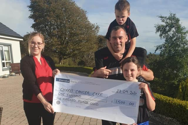 Accepting a cheque on behalf of Charis handed over by Angela McCabe's husband Frank and children Emma and Michael.