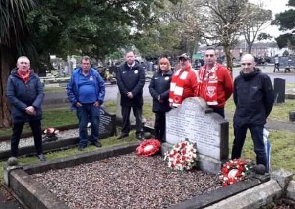 Larne FC officials and supporters pictured at Frank Gardiner's grave.