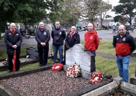 Fans of Ballyclare Comrades and club officials at Frank Gardiner's grave.