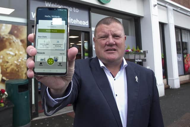 Jackie Wright, owner of Whitehead Spar,with the phone app.