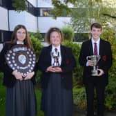Ellie Gould, Emily Clugston and Owen Beckington being congratulated on their achievements by Head of Year 11, Mrs Montgomery.