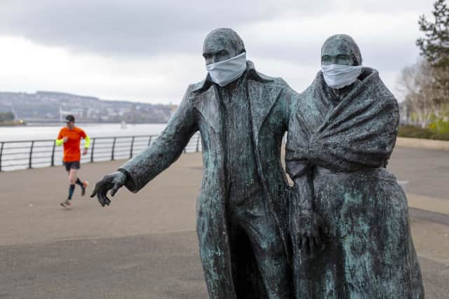 Press Eye - Belfast - Northern Ireland - 22nd April 2020 -  

General view of â€ ̃The Emigrantsâ€TM by artist Eamonn Oâ€TMDoherty on Derryâ€TMs quayside after someone attached surgical masks to the statue/

Photo by Lorcan Doherty / Press Eye.