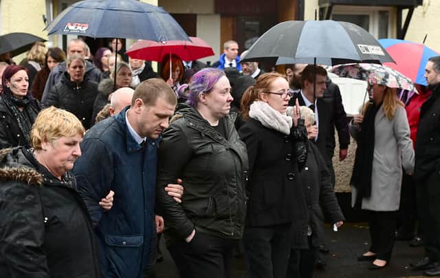 Brooke Reid's mother Martha (centre) with family and friends at her 12-year-old daughter's funeral in Ballymena