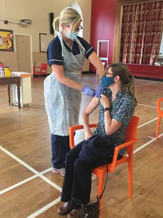 Maine Medical Practice nurse Tara Agnew giving patient, Sally Ann  her flu vaccination at the Cunningham Memorial Church Hall in Cullybackey