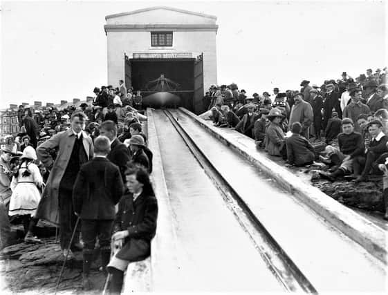 Townsfolk eagerly await practice launch of the Lifeboat Hopwood at the Boathouse and Slipway at Lansdowne. Circa 1912