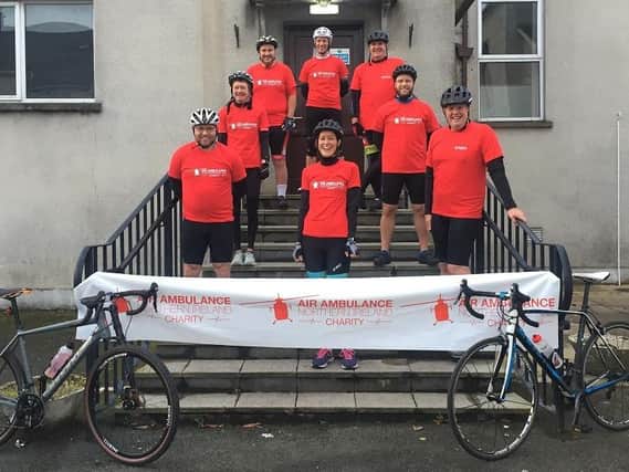 The team of eight cycling enthusiasts pose for a photo before their 85 mile fundraising event in aid of Air Ambulance NI.