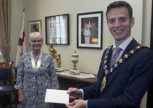 The Mayor of Mid and East Antrim, Councillor Peter Johnston, presents a cheque to Patricia Perry, the new District Chairman of Inner Wheel District 16, which covers the whole of Ireland