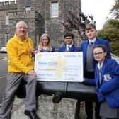 Year 8 pupils who took part in the walk presenting Phil Kane from Marie Curie with a cheque for £4500.