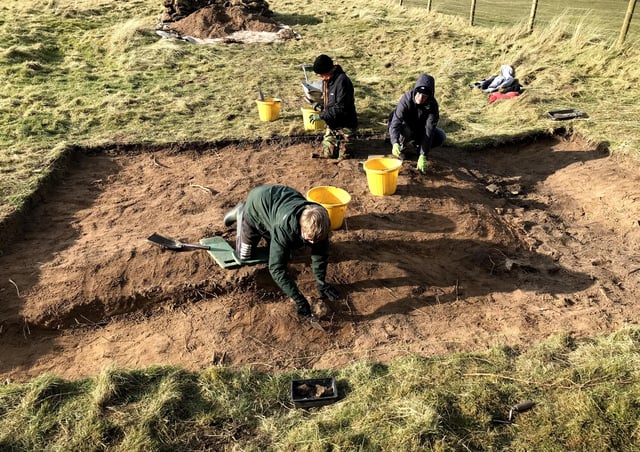 The Higgins family in Trench 2 excavating the cremelated fire trench