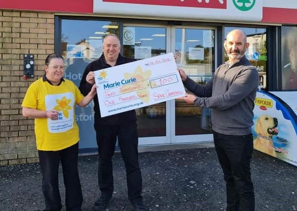 Jackie Fenton and Ronnie Eynon, from Spar Craigyhill, presenting Conor O’Kane, Marie Curie, with a cheque for £2,100 from the store's recent fundraising.
