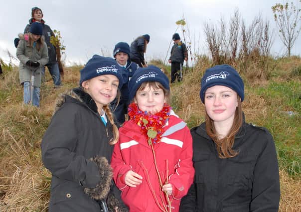 Corran Integrated Primary School P5 pupils helped plant trees in the Seaview Wood. Above Kavaghn and Morgan plant trees with Jenny Kitson from Slemish College who was with the school on work experience.  LT47-346-PR