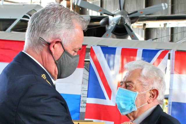 Netherlands Defence Attache to the UK Captain Gerrit Nijenhuis RNN pins Fred Jennings' Thank you Liberators 1945 Remembrance Medal above his existing medals