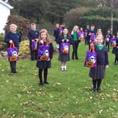 Ballycarry Prirmary School pupils with their early Halloween treats.