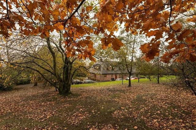 The property is positioned on an exceptional wooded site extending to approximately two acres