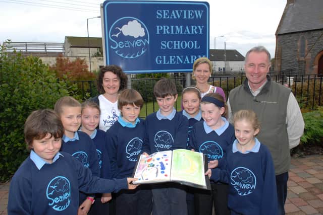 George Blackwood, the Regional Learning Manager with the National Trust, along with parents Sue McBride and Hilary Cross are shown some of the sketches that were used to plan the vegetable plot at Seaview Primary School designed by P6 and P7 pupils. LT41-392-PR