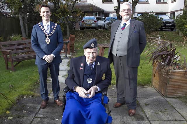 The Mayor of Mid and East Antrim, Cllr Peter Johnston, and Alderman John Carson, council's veterans' champion, who presented William Boyce with gifts to mark his 100th birthday.